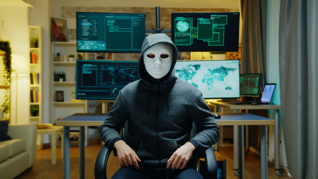 Cyber criminal wearing a white mask using augmented reality