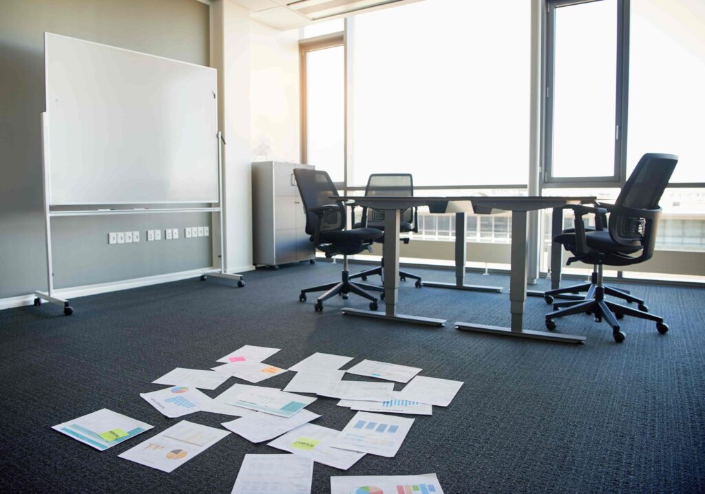 Empty office with papers strewn across the floor, business interruption