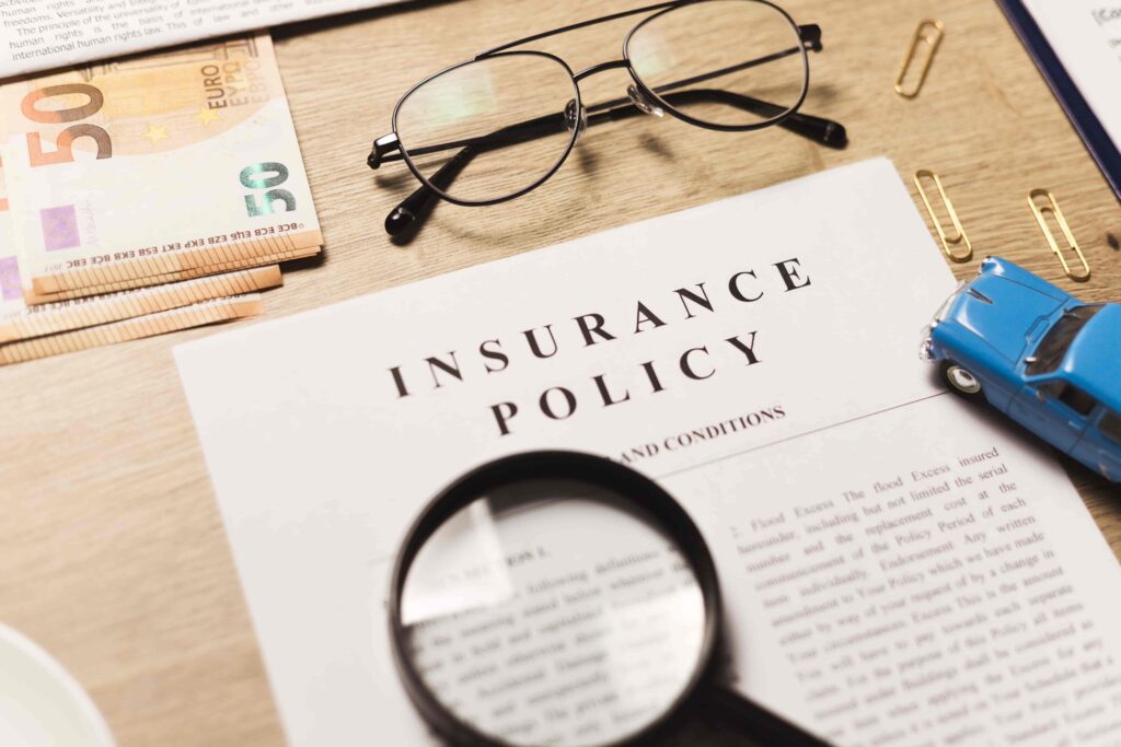 A comprehensive insurance policy under a magnifying glass.